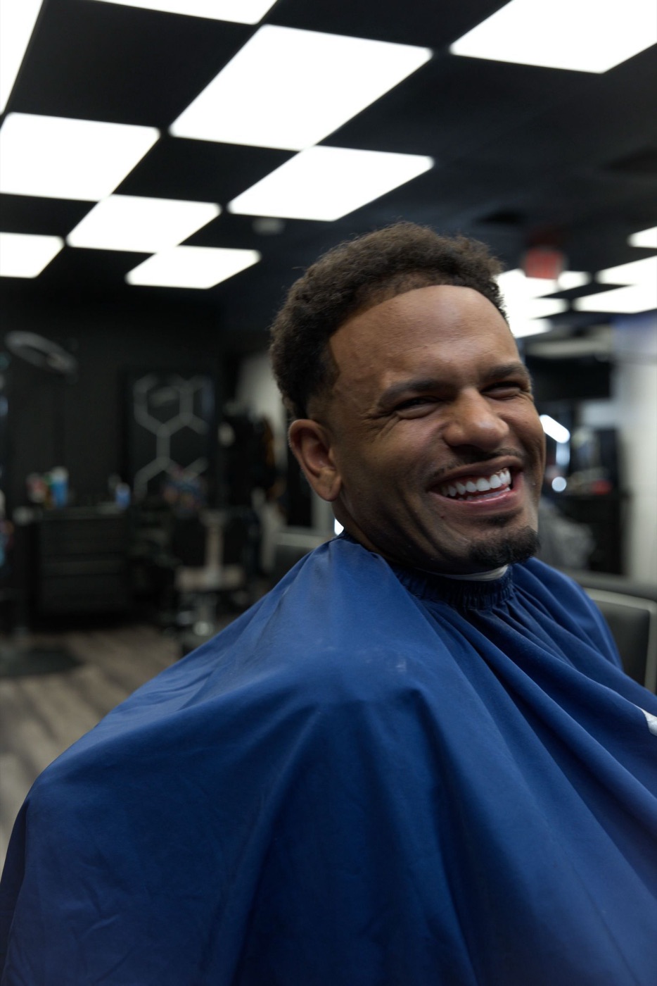 Client laughing in the chair after his cut