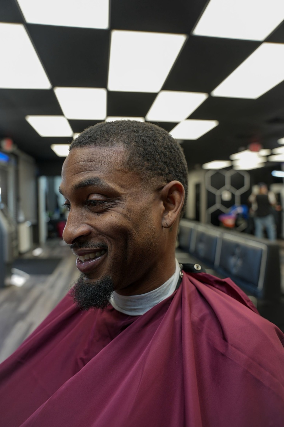 Smiling client after a haircut and beard lineup