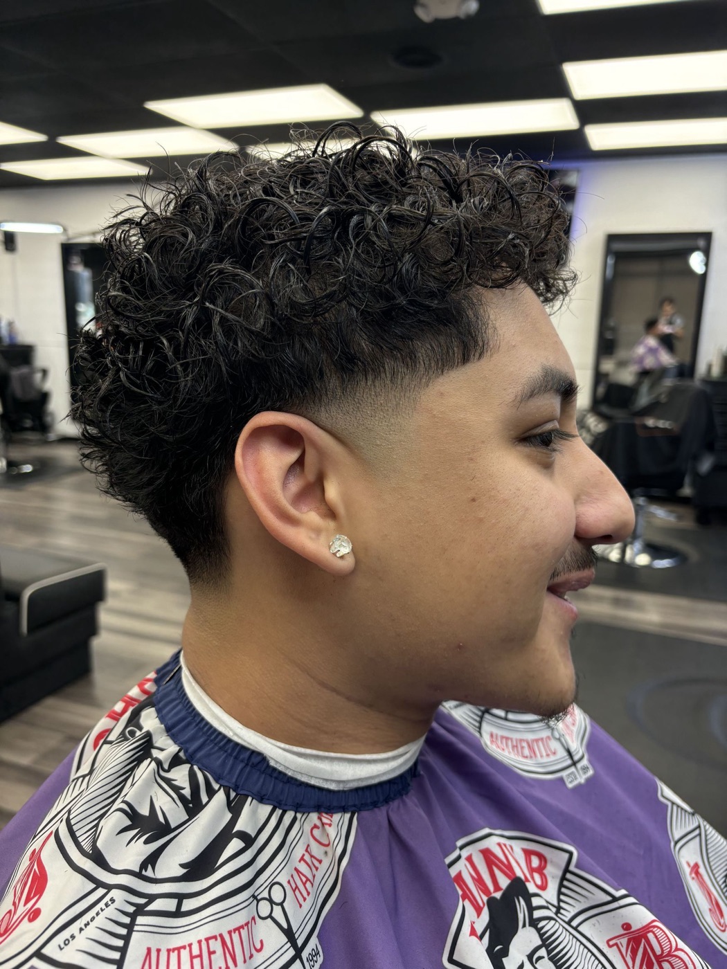 Curly top with a clean burst fade