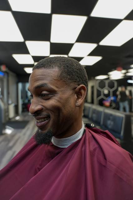 Client smiling after his cut