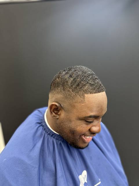 Client grinning after a fade