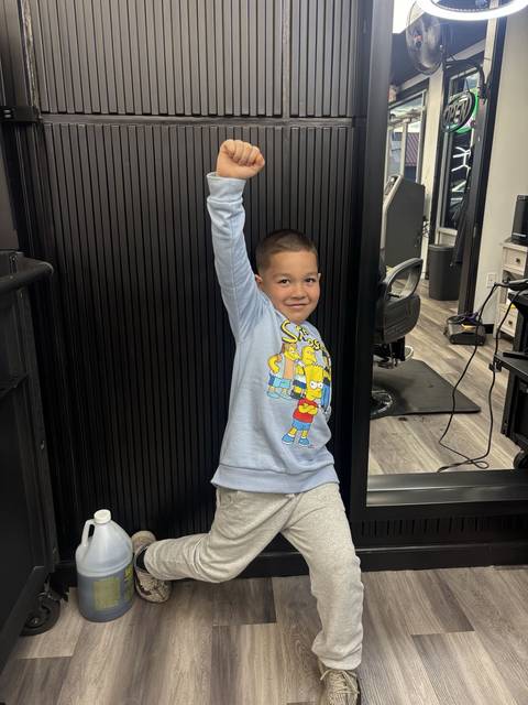 Young client celebrating his fresh cut