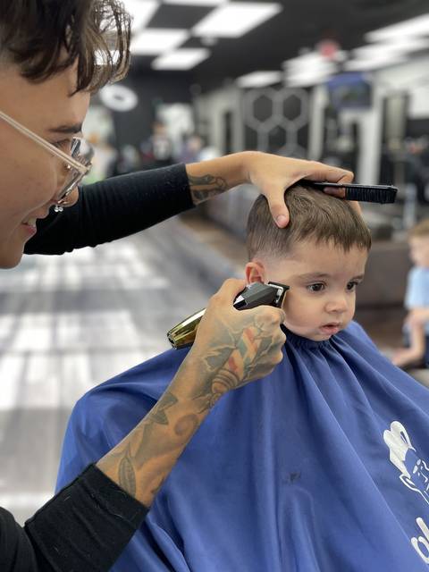 Steph cutting a toddler's hair