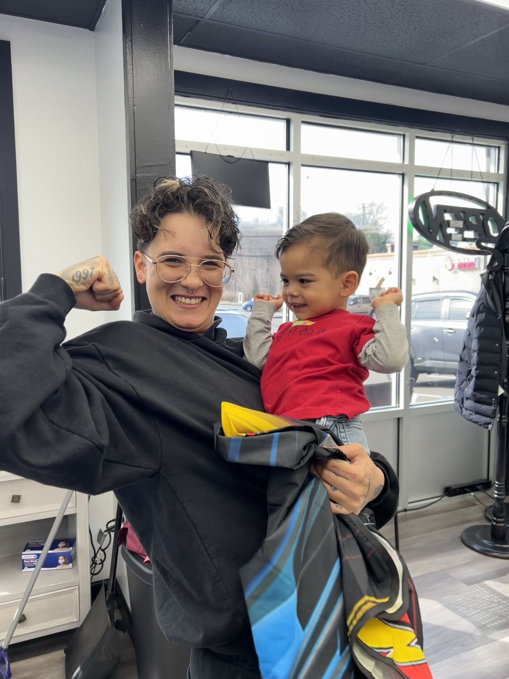 Steph flexing with a young client after his first haircut